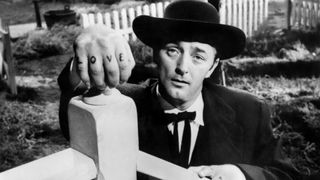 Robert Mitchum as Harry Powell in The Night of the Hunter